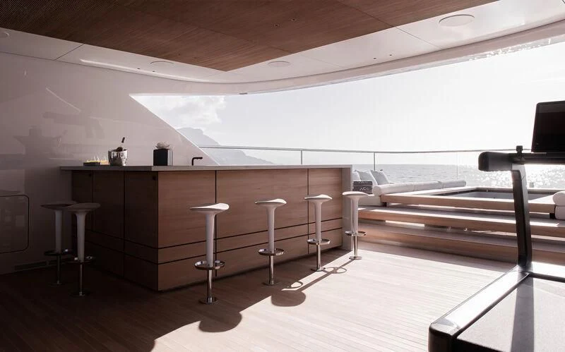 a room with tables and chairs aboard ACE Yacht for Sale