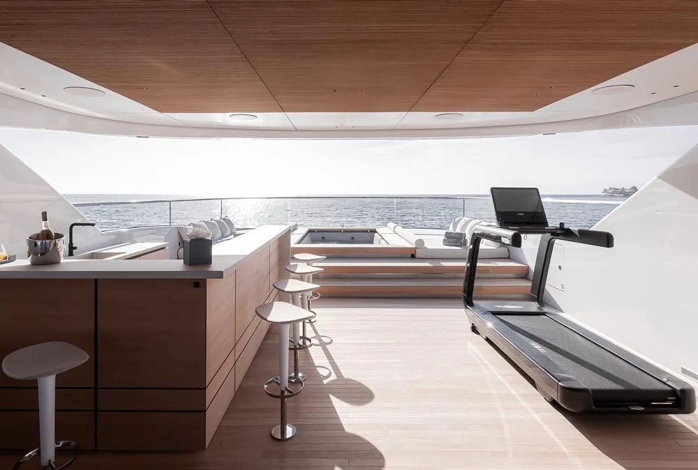 a room with a view of the water and a boat aboard ACE Yacht for Sale