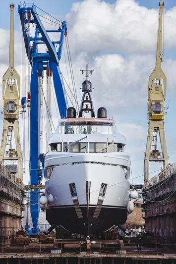 a large white boat in a dock aboard ACE Yacht for Sale