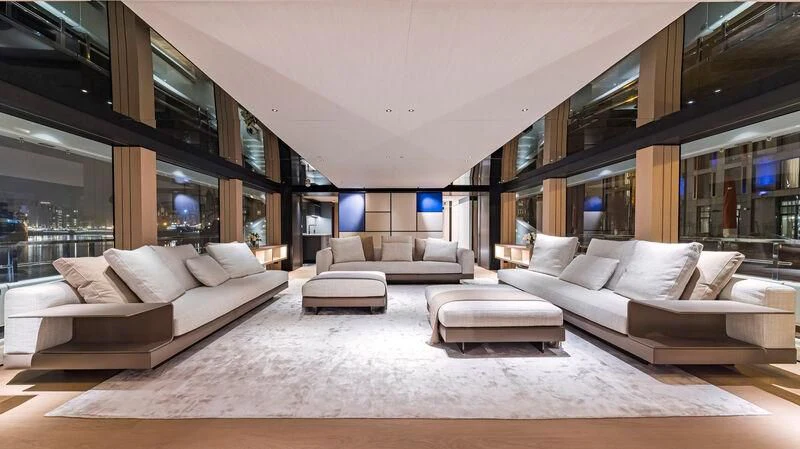 a large room with a couch and a table aboard ACE Yacht for Sale