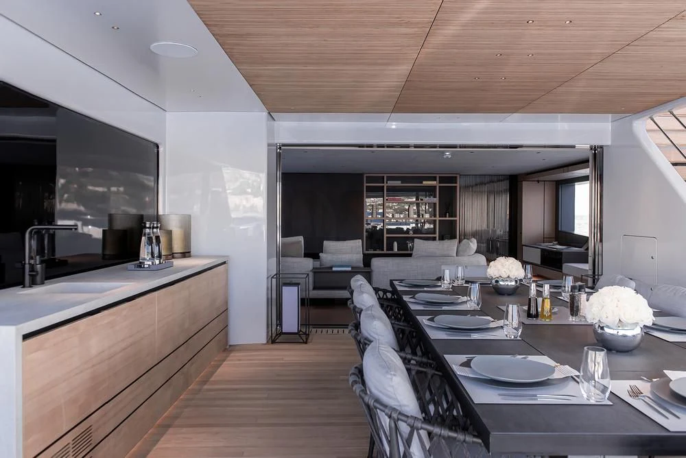a modern looking kitchen and dining area aboard ACE Yacht for Sale