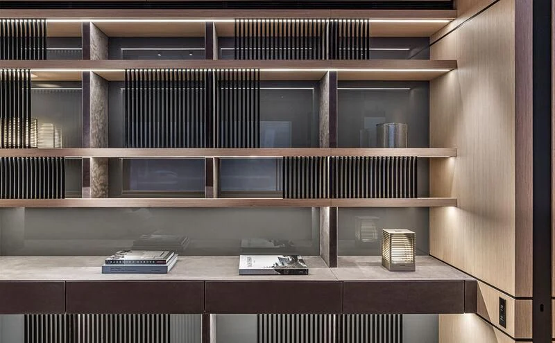 a desk with a computer and books on it aboard ACE Yacht for Sale