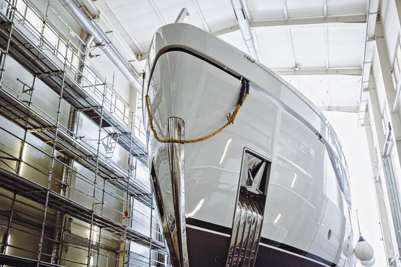 a large white building with a large clock on it aboard ACE Yacht for Sale