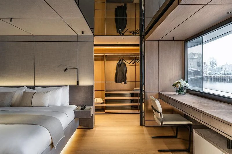 a room with a bed and a desk aboard ACE Yacht for Sale