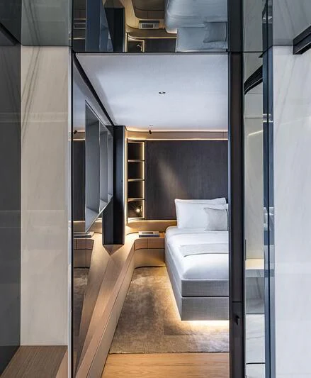 a room with a bed and a couch aboard ACE Yacht for Sale