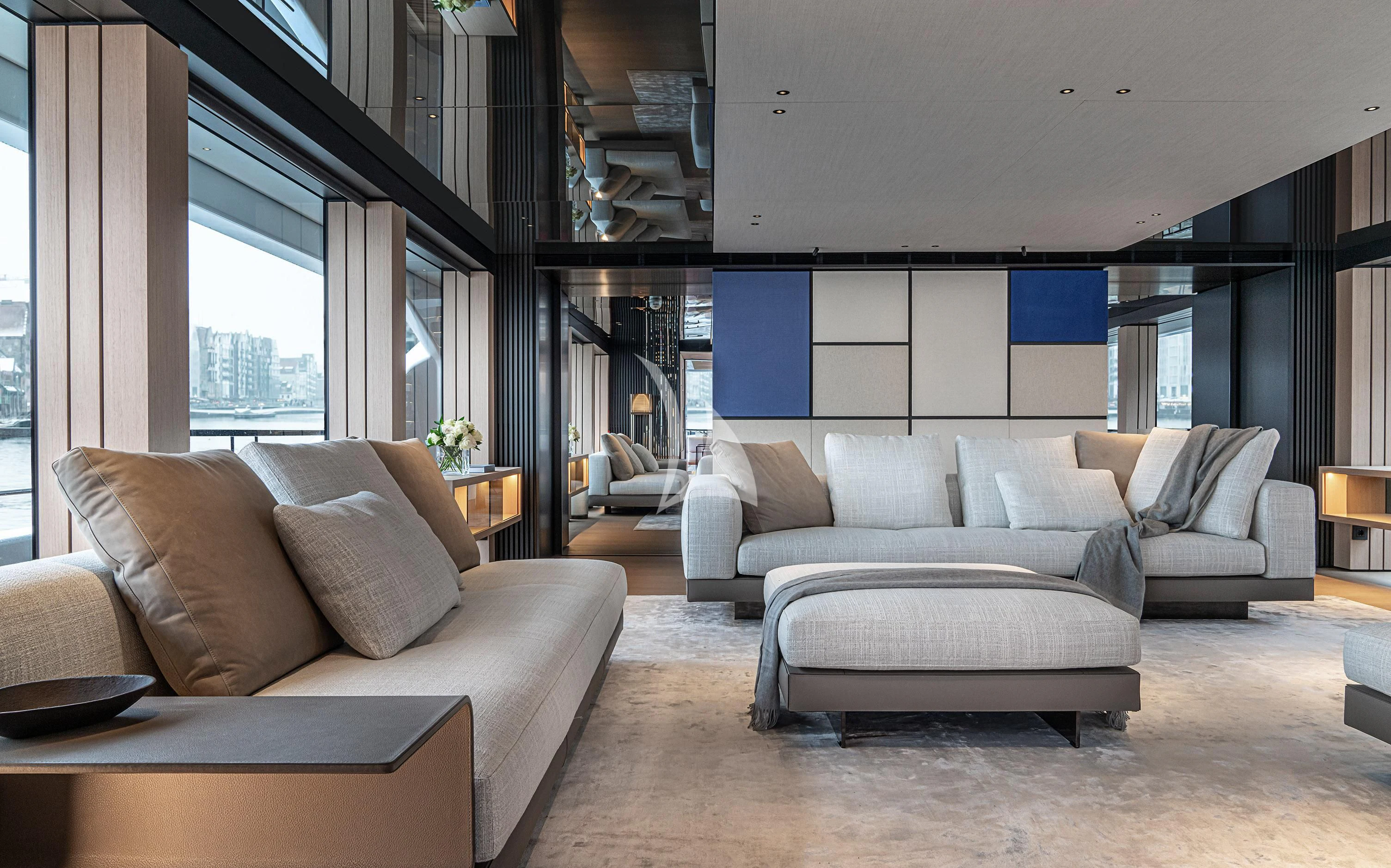 a living room with couches and a table aboard ACE Yacht for Sale