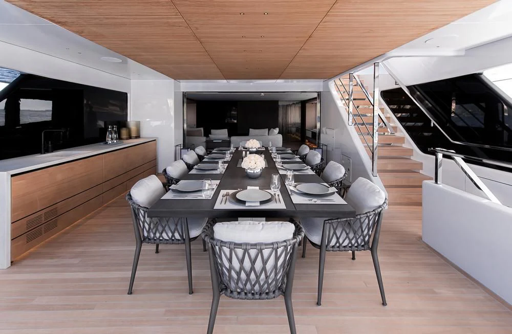 a large kitchen and dining area aboard ACE Yacht for Sale