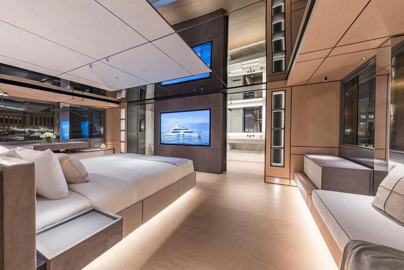 a room with a couch and a tv on the wall aboard ACE Yacht for Sale