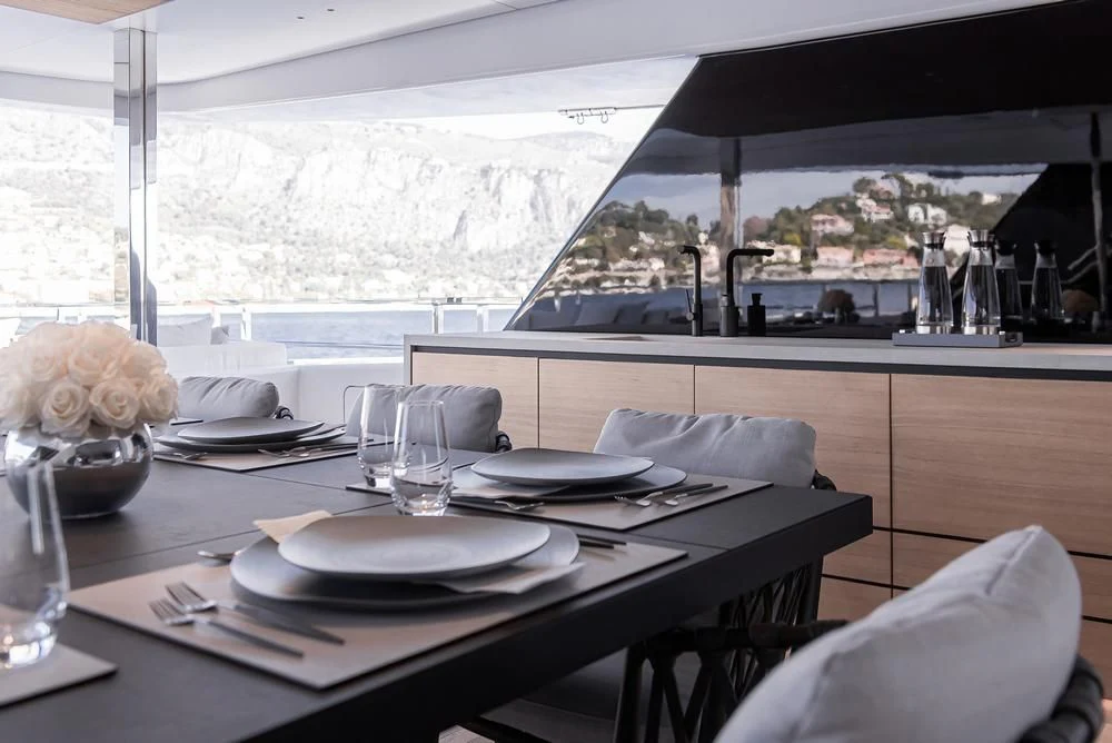 a table with plates and glasses on it aboard ACE Yacht for Sale