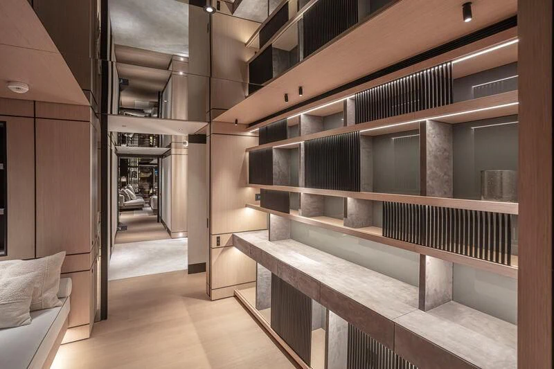 a room with wooden shelves aboard ACE Yacht for Sale