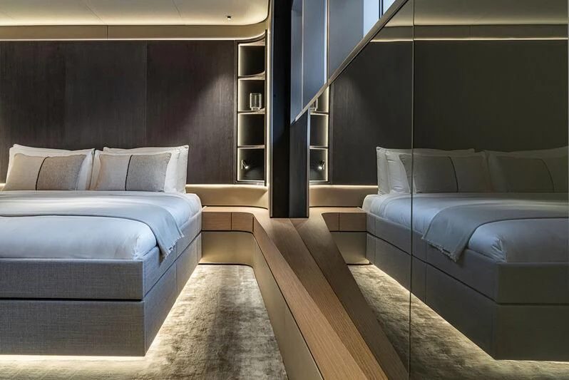 a room with beds and a window aboard ACE Yacht for Sale