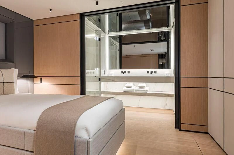 a bedroom with a bed and a closet aboard ACE Yacht for Sale