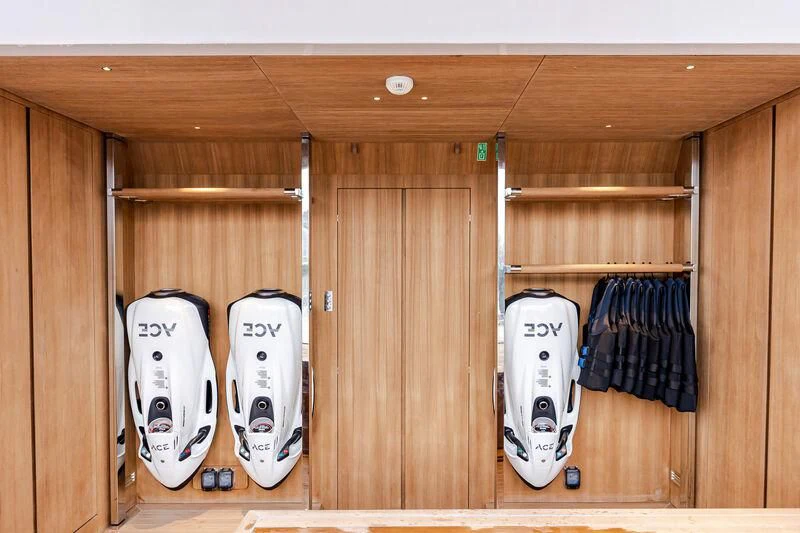 a white skateboard and a white board in a closet aboard ACE Yacht for Sale