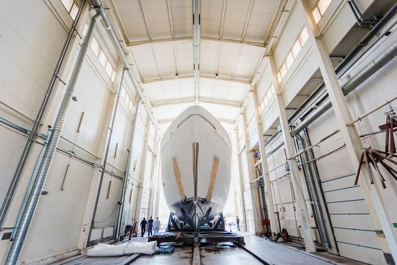 a large white building with a large white staircase and people standing on the stairs aboard ACE Yacht for Sale