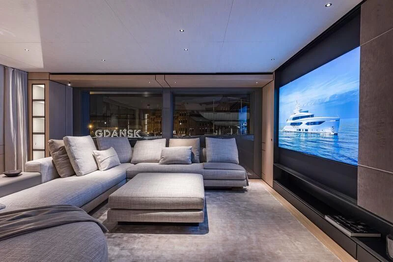 a living room with a large screen aboard ACE Yacht for Sale