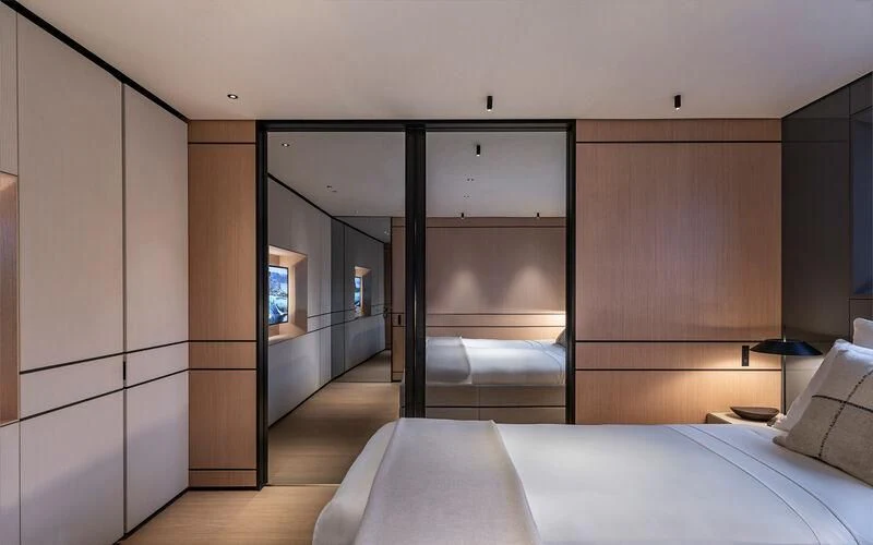 a bedroom with a bed and a closet aboard ACE Yacht for Sale