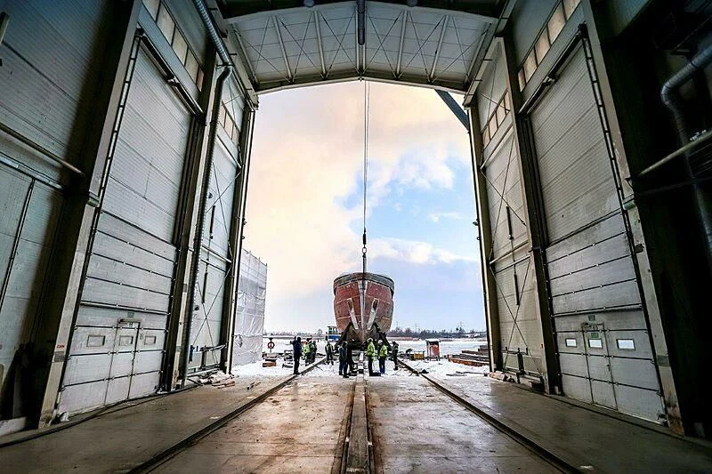 a group of people standing on a train track aboard ACE Yacht for Sale