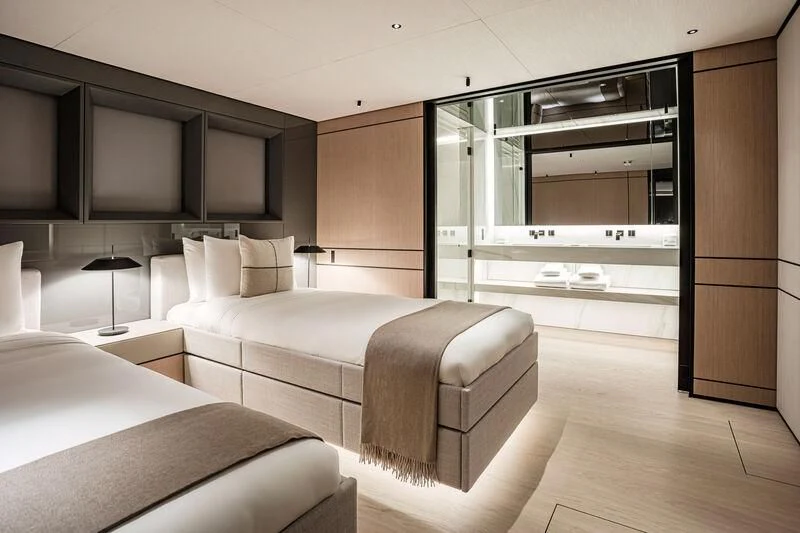 a room with a bed and a large mirror aboard ACE Yacht for Sale