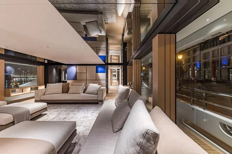 a modern living room with a large glass wall aboard ACE Yacht for Sale