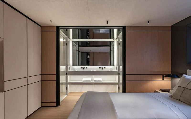 a bedroom with a bed and a closet aboard ACE Yacht for Sale