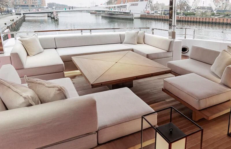 a room with couches and a table in it aboard ACE Yacht for Sale