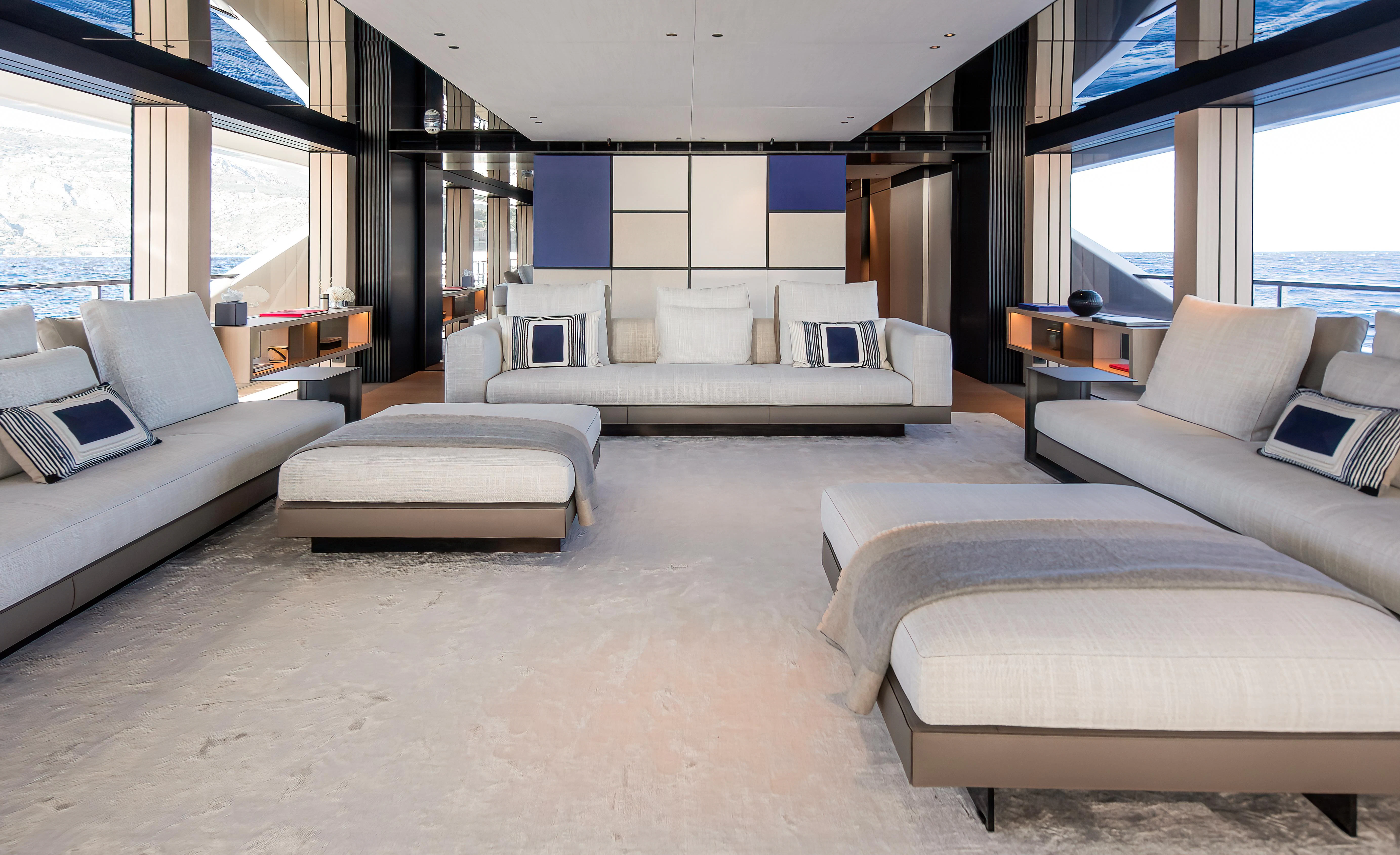 a large living room with white couches and a large window aboard ACE Yacht for Sale