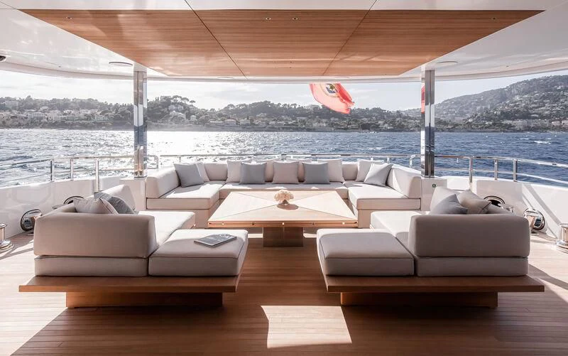 a room with couches and a table and chairs aboard ACE Yacht for Sale