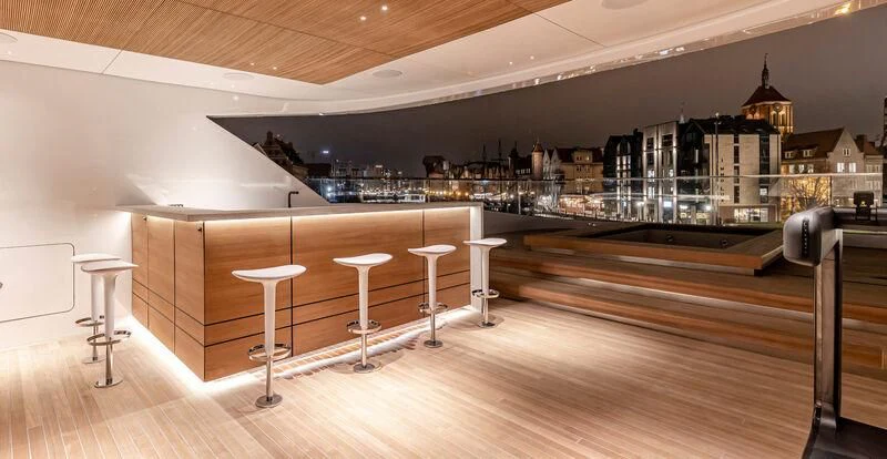 a bar with stools and stools aboard ACE Yacht for Sale