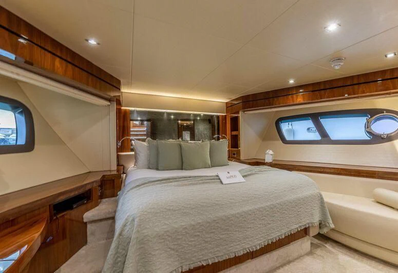 a room with a bed and a window aboard HIGH ENERGY Yacht for Sale