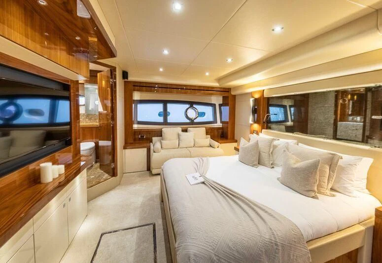 a room with a bed and a tv aboard HIGH ENERGY Yacht for Sale