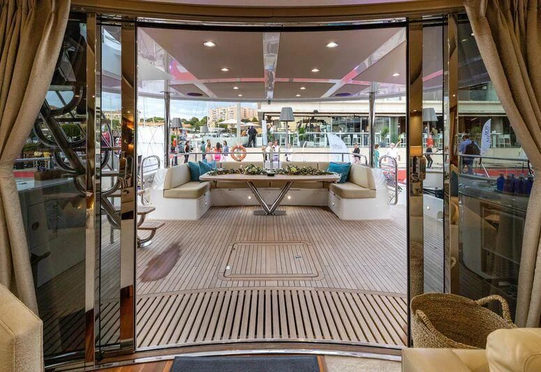 a room with a table and chairs aboard HIGH ENERGY Yacht for Sale