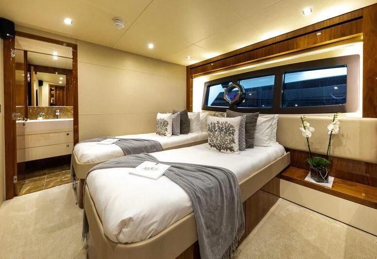 a hotel room with a bed and a tv aboard HIGH ENERGY Yacht for Sale