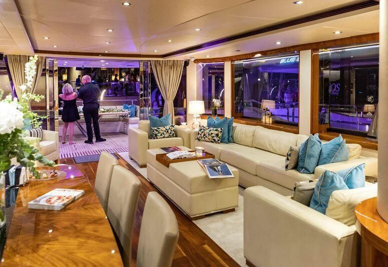 a living room with a couch and a table aboard HIGH ENERGY Yacht for Sale