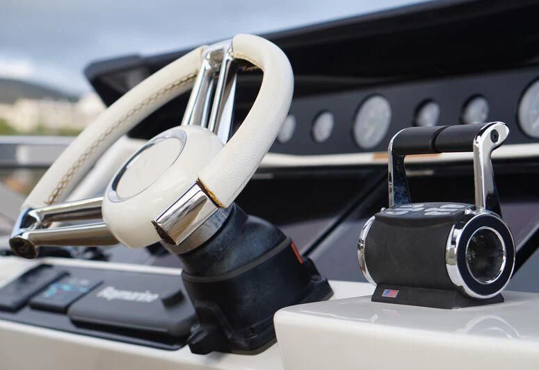 a steering wheel and dashboard of a car aboard HIGH ENERGY Yacht for Sale