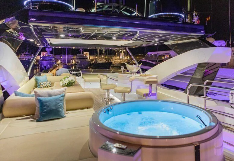 a large room with a round table and chairs and a large blue and white object with a purple aboard HIGH ENERGY Yacht for Sale