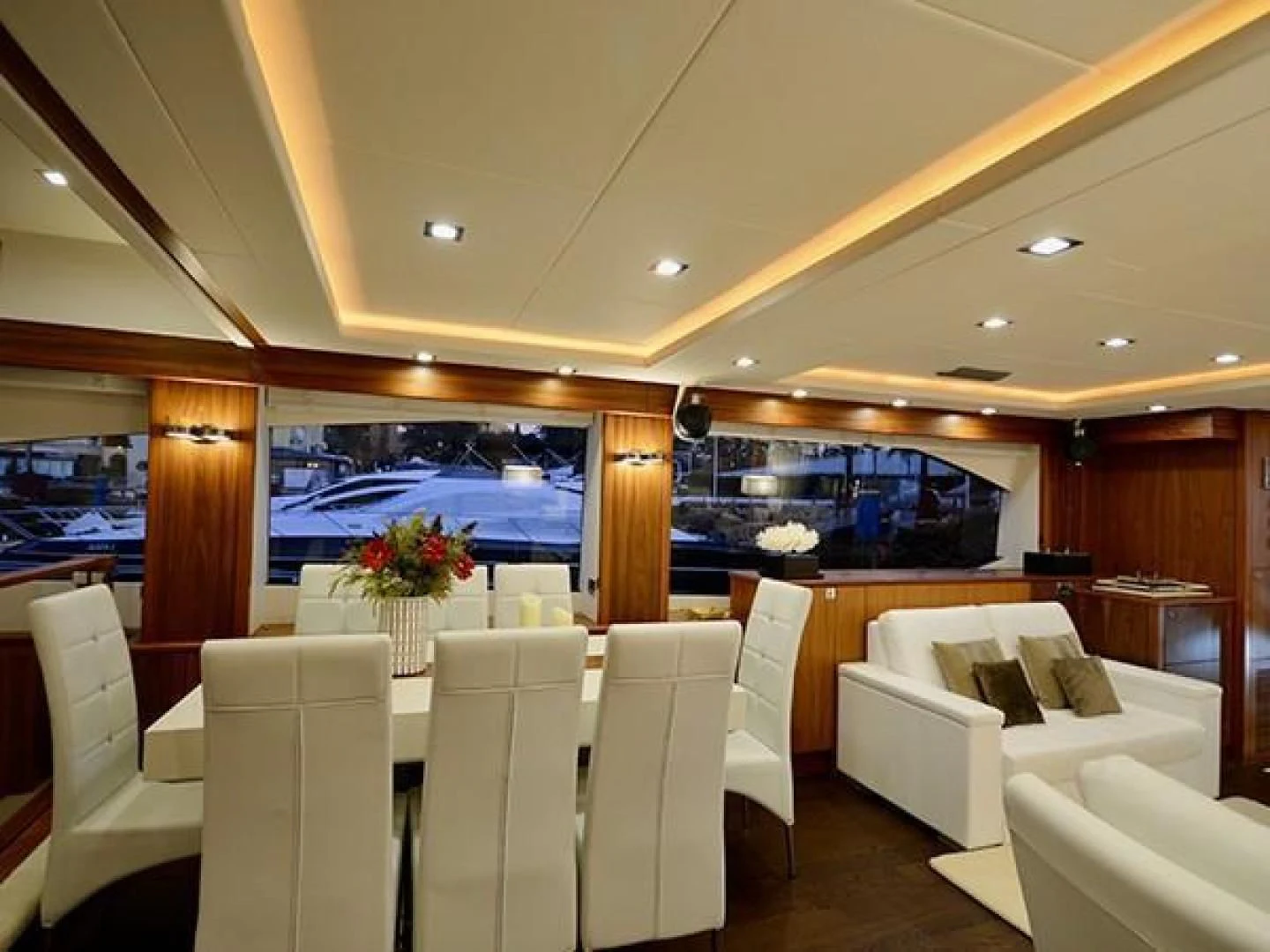 a room with white chairs and a large screen aboard EXIMIUS Yacht for Sale