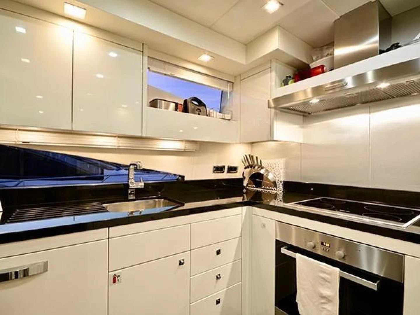 a kitchen with white cabinets aboard EXIMIUS Yacht for Sale