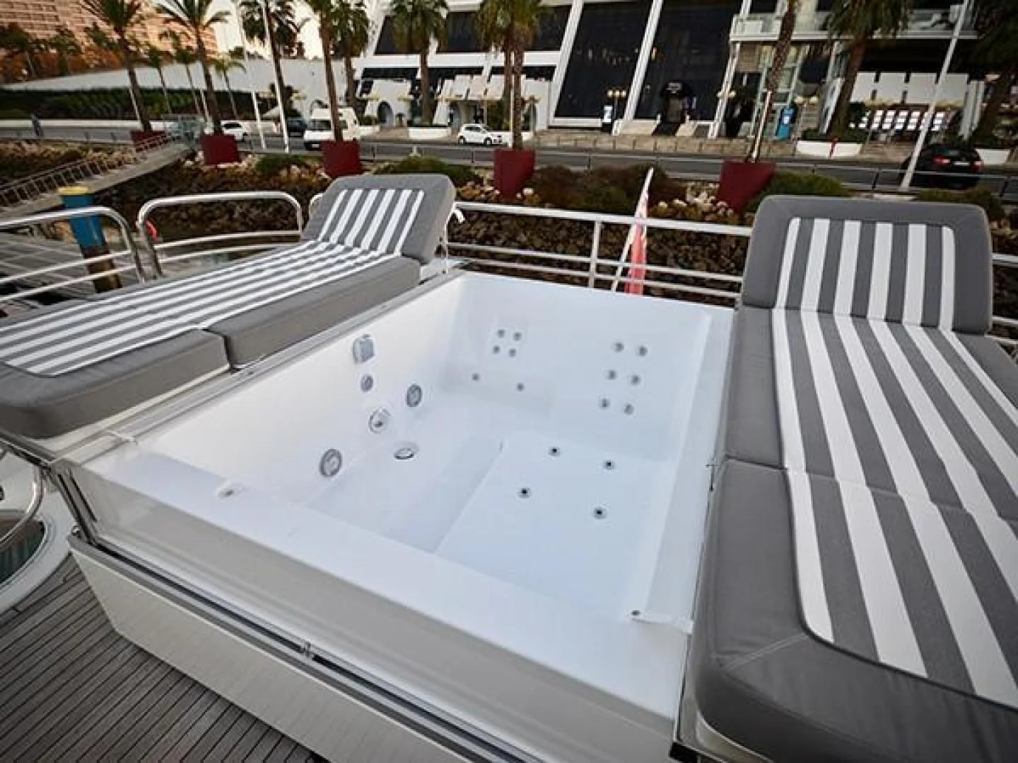 a white pool with a white chair and a white chair on the side aboard EXIMIUS Yacht for Sale