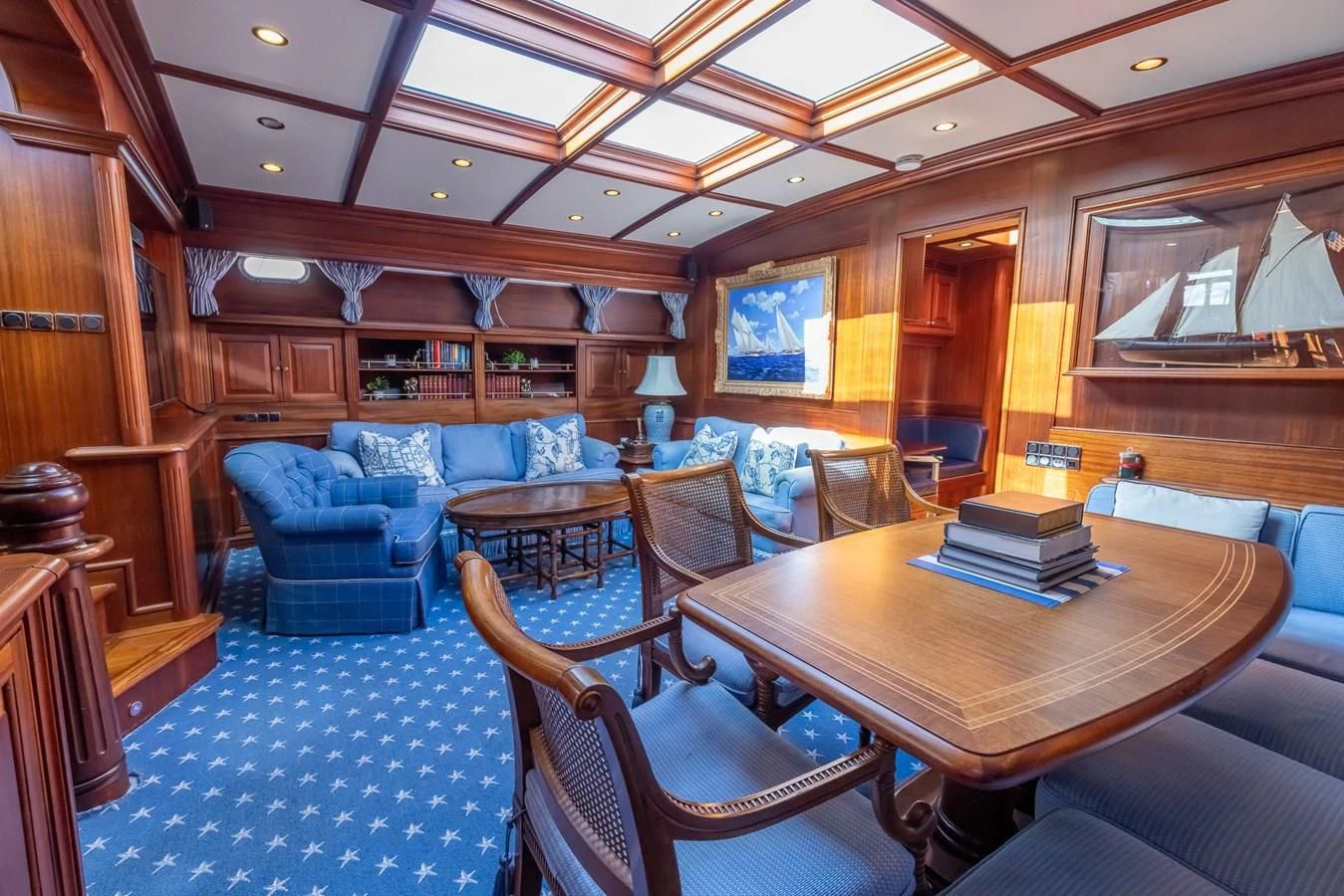 a room with a table chairs and a couch aboard 85 CLASSIC Yacht for Sale