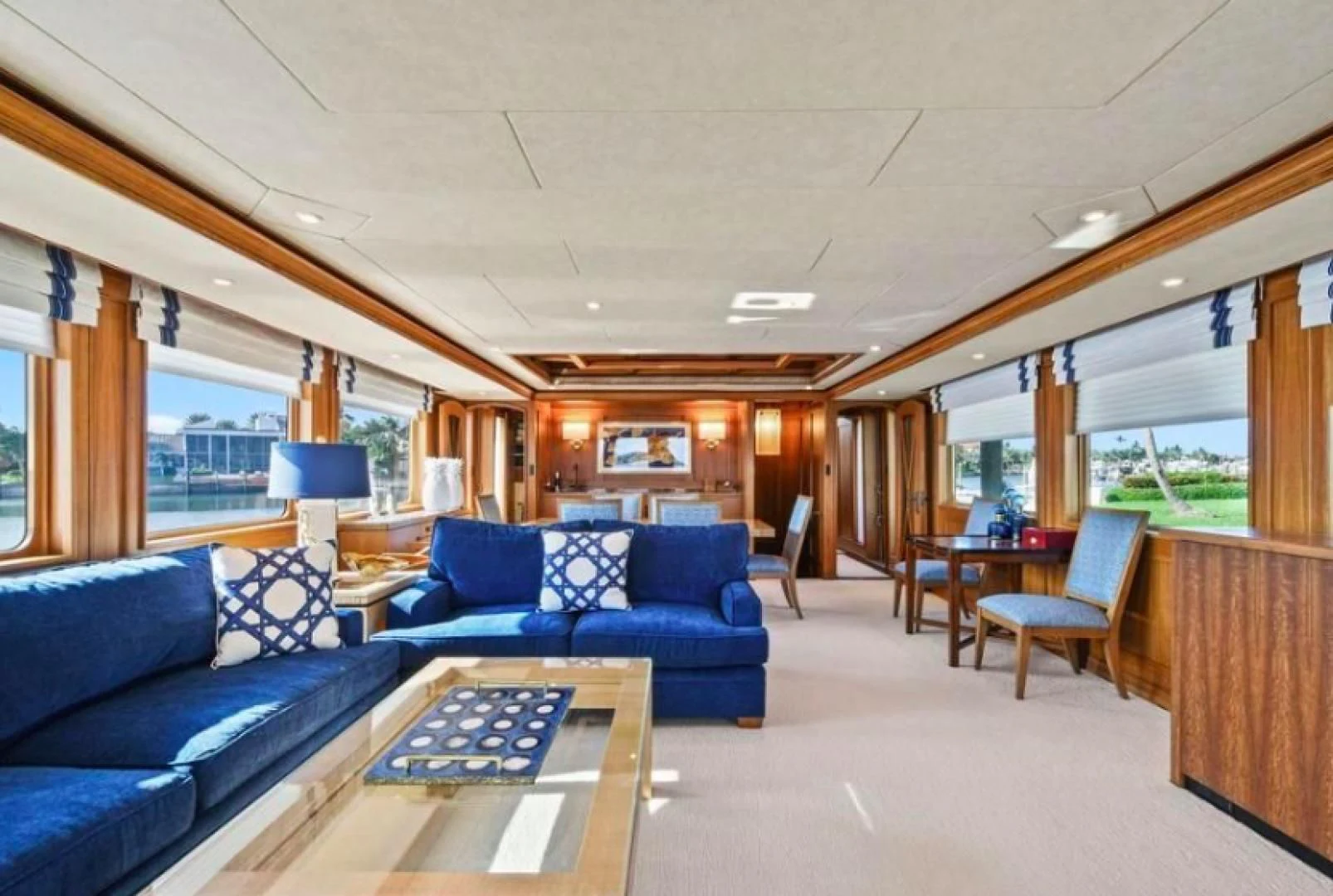 a living room with a blue couch aboard HAU TREE Yacht for Sale