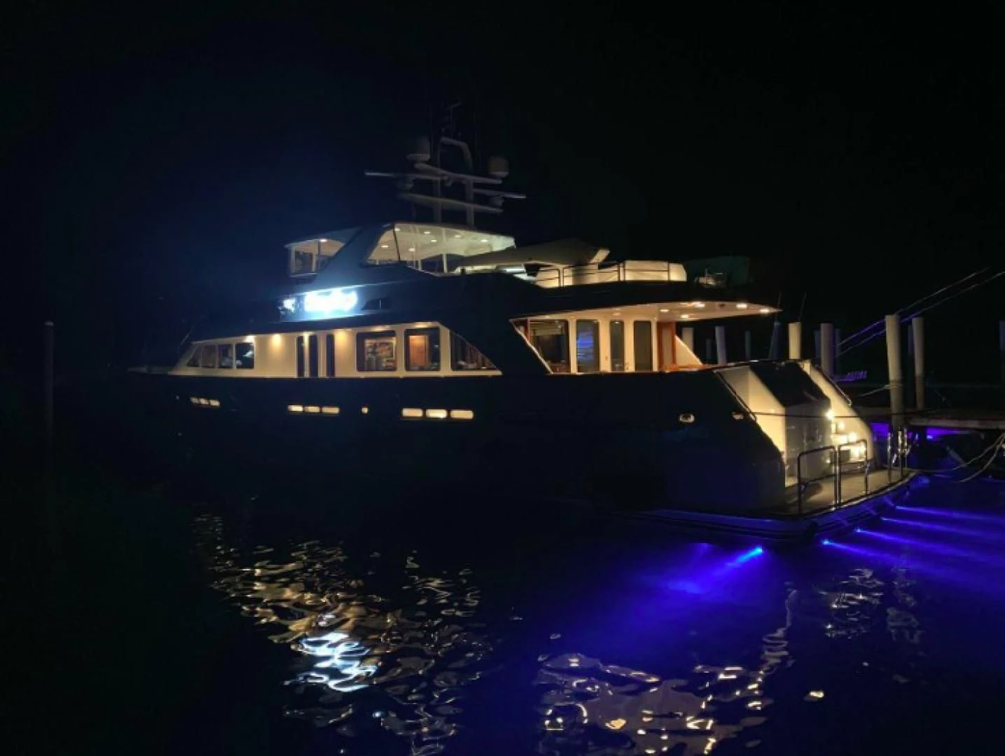 a large boat at night aboard HAU TREE Yacht for Sale