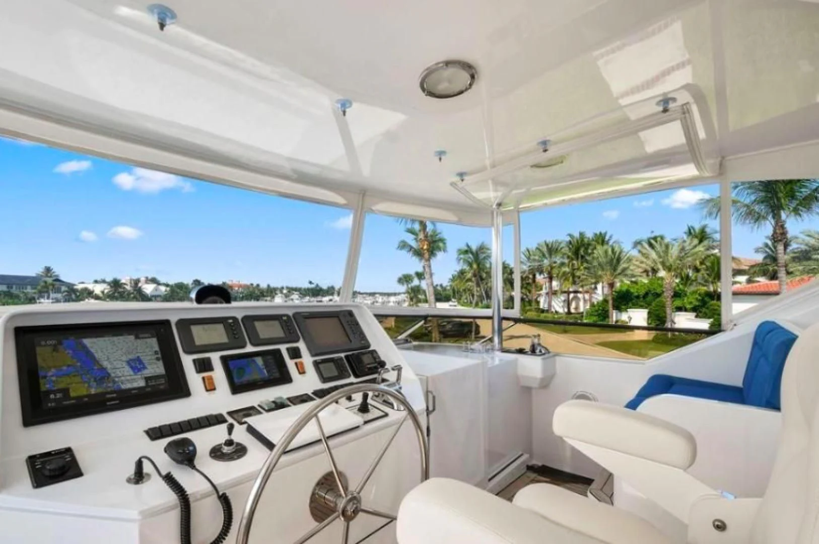 inside of a white car with a large white window and a view of the beach and palm trees aboard HAU TREE Yacht for Sale