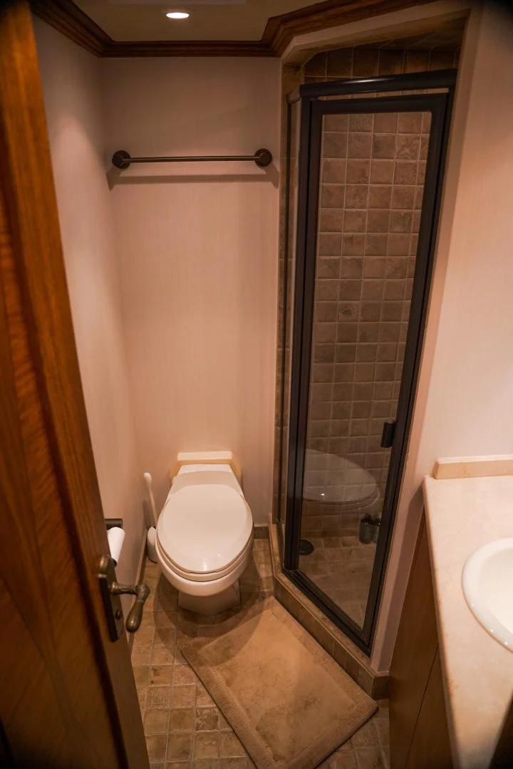 a bathroom with a toilet and sink aboard HAU TREE Yacht for Sale