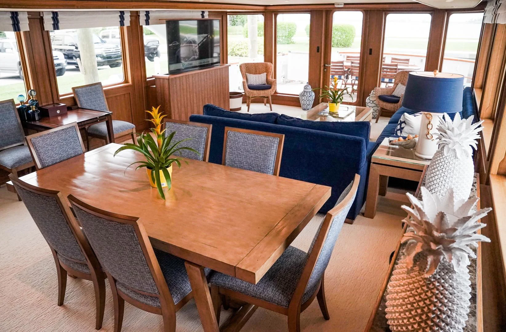 a dining table with chairs and a plant on it aboard HAU TREE Yacht for Sale