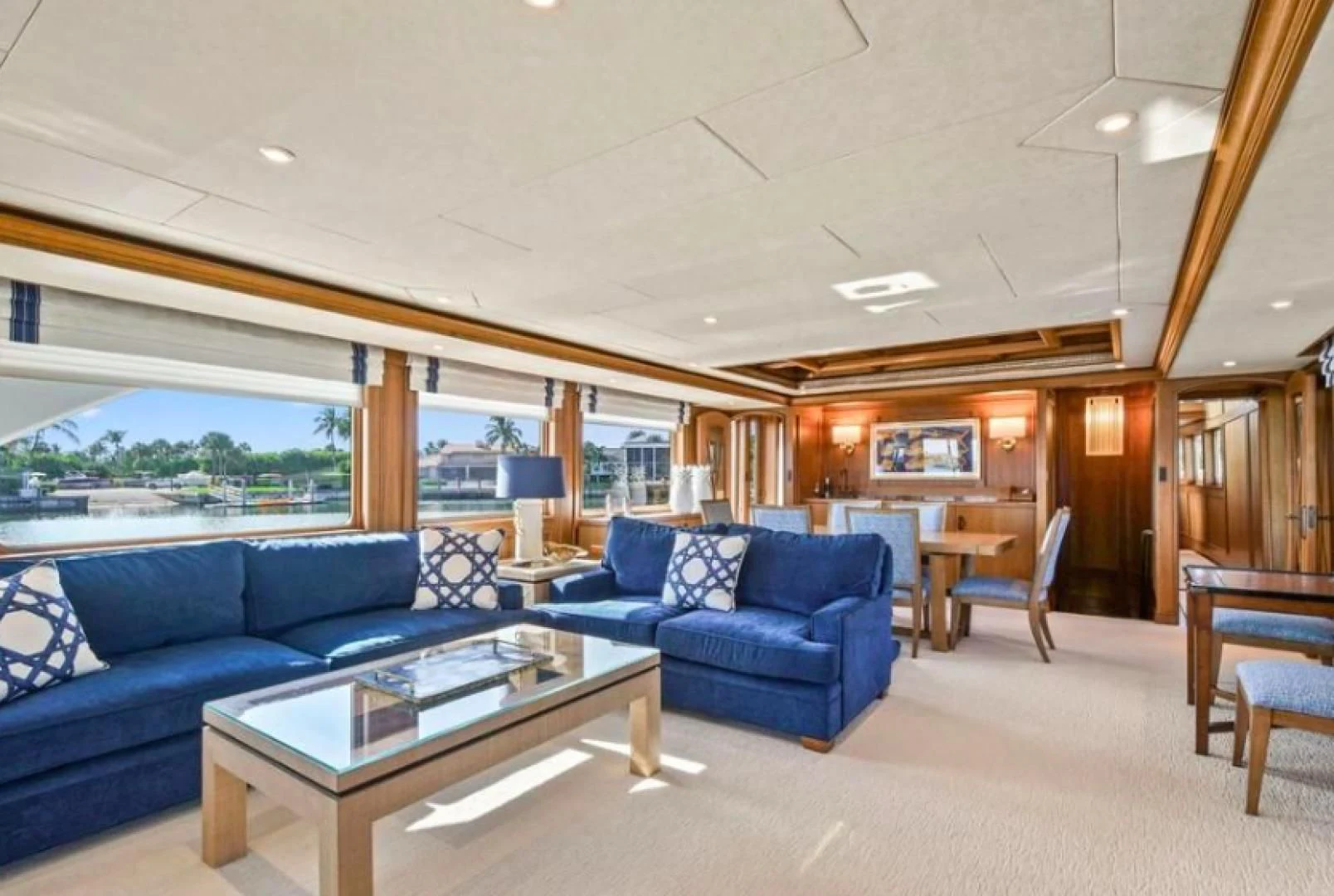 a living room with a blue couch aboard HAU TREE Yacht for Sale