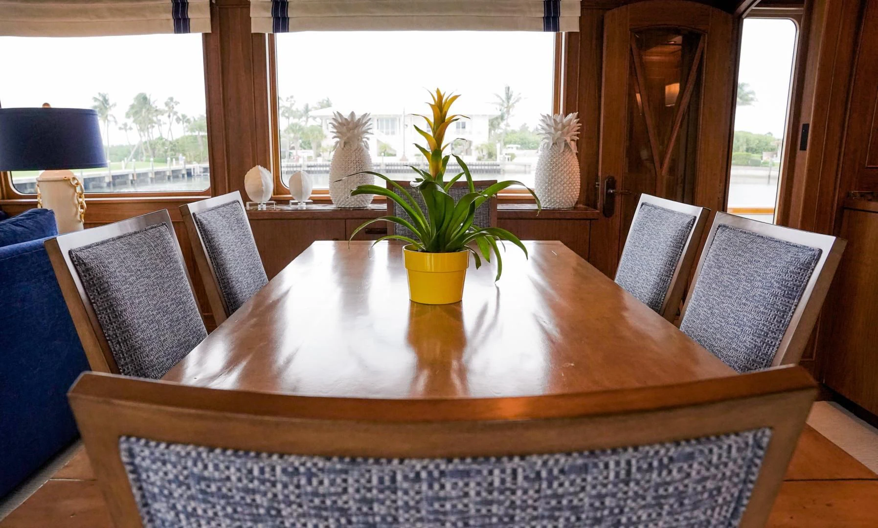 a table with chairs and plants aboard HAU TREE Yacht for Sale