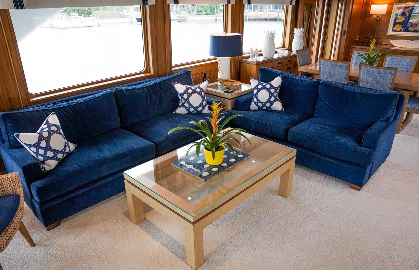 a living room with blue couches aboard HAU TREE Yacht for Sale
