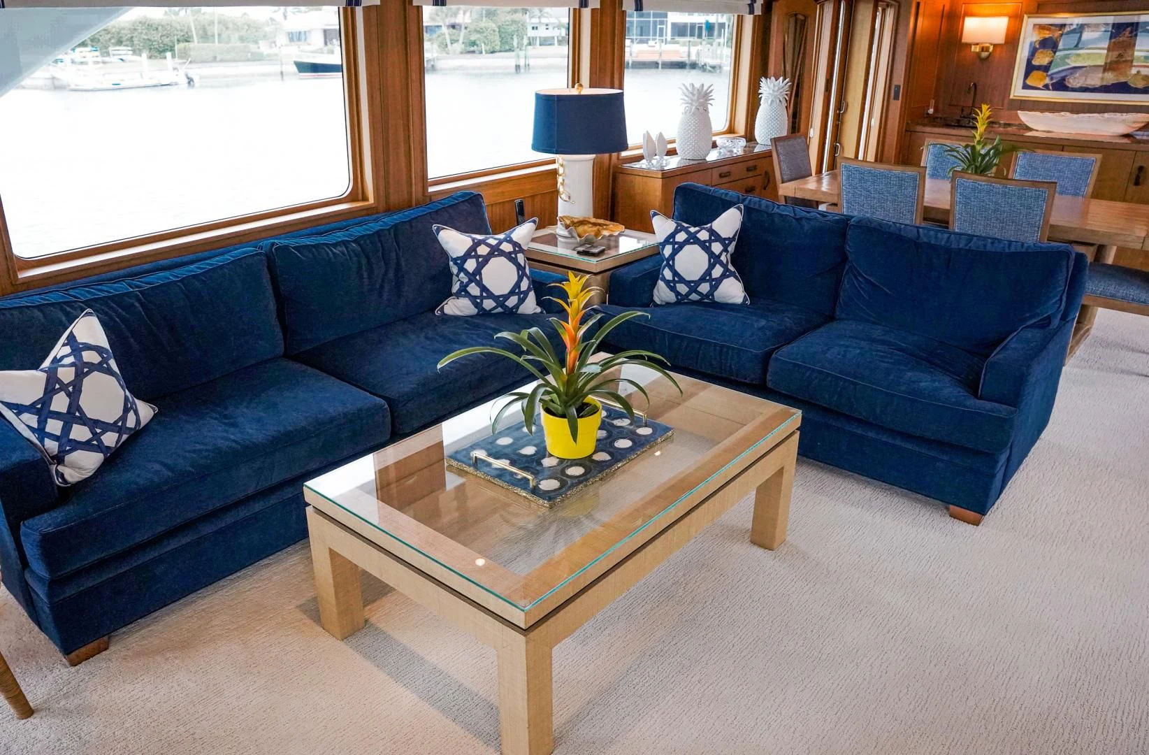 a living room with blue couches aboard HAU TREE Yacht for Sale