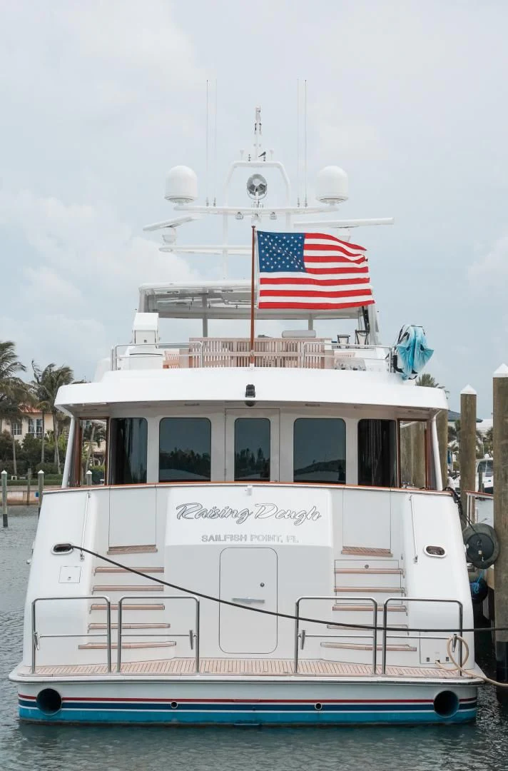 a boat with a flag on it aboard HAU TREE Yacht for Sale