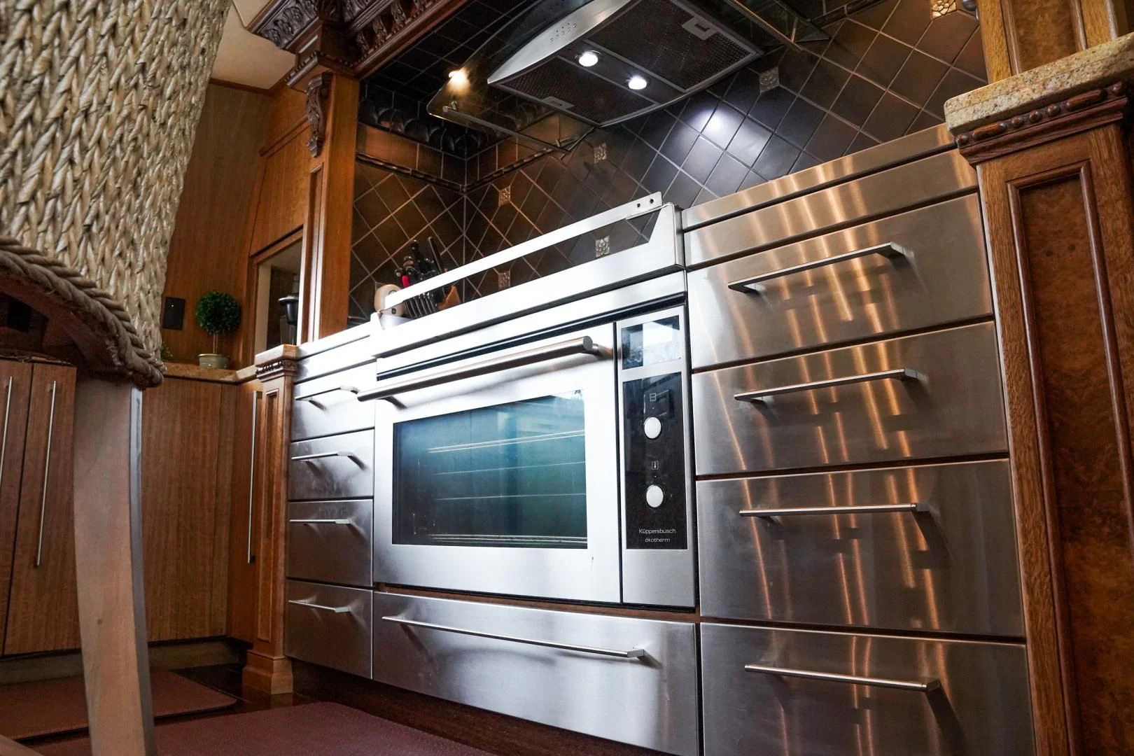 a kitchen with wooden cabinets aboard HAU TREE Yacht for Sale
